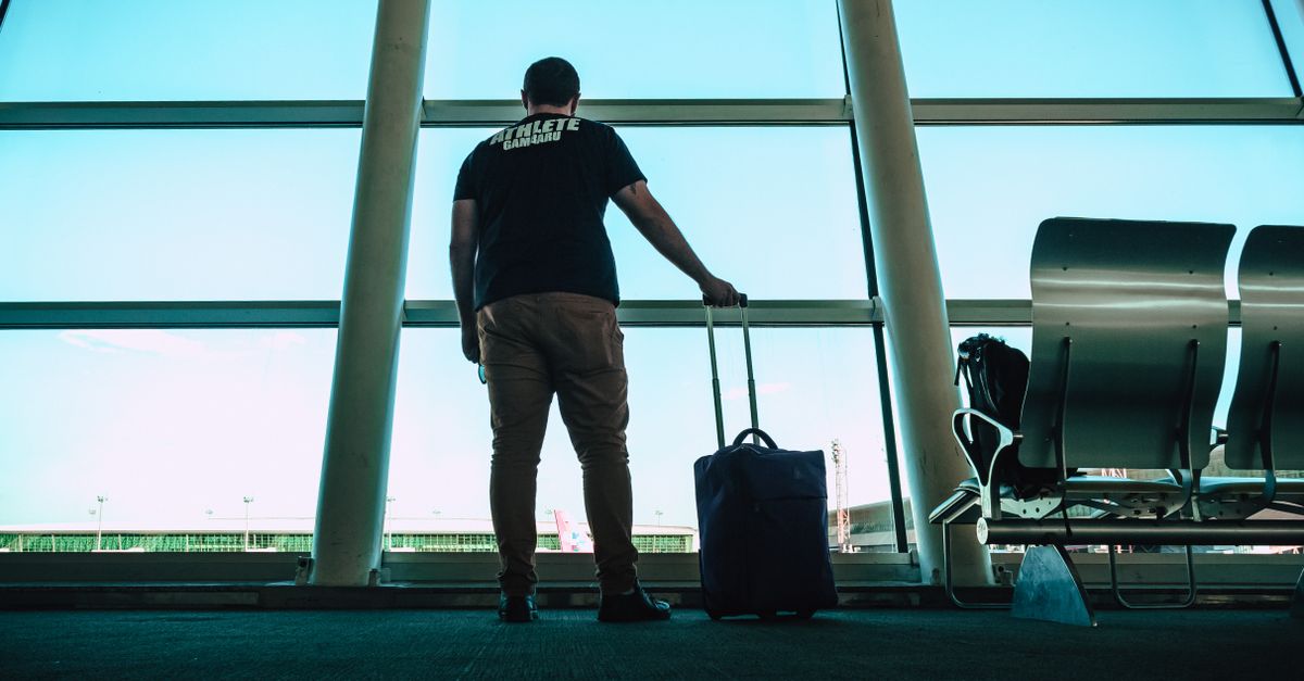 Expat with suitcase airport